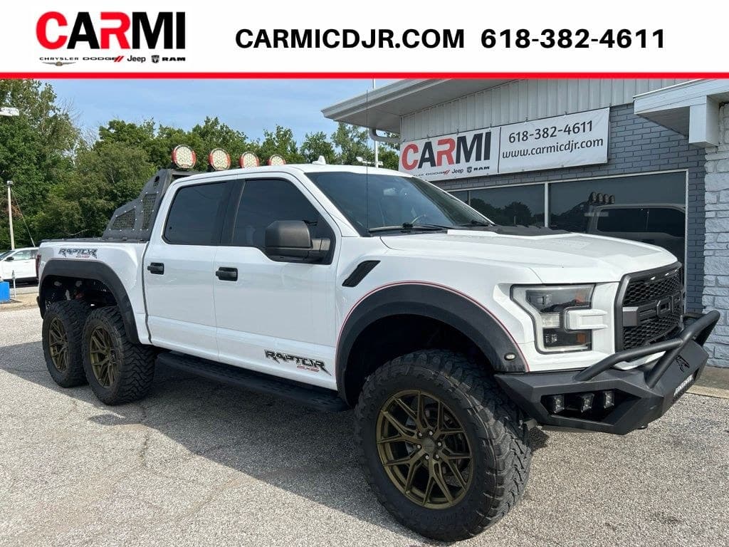 2020 Ford F-150 Raptor 6x6 in Oxford White — front three-quarter view showing the tandem rear axles, for sale from DDE Rentals
