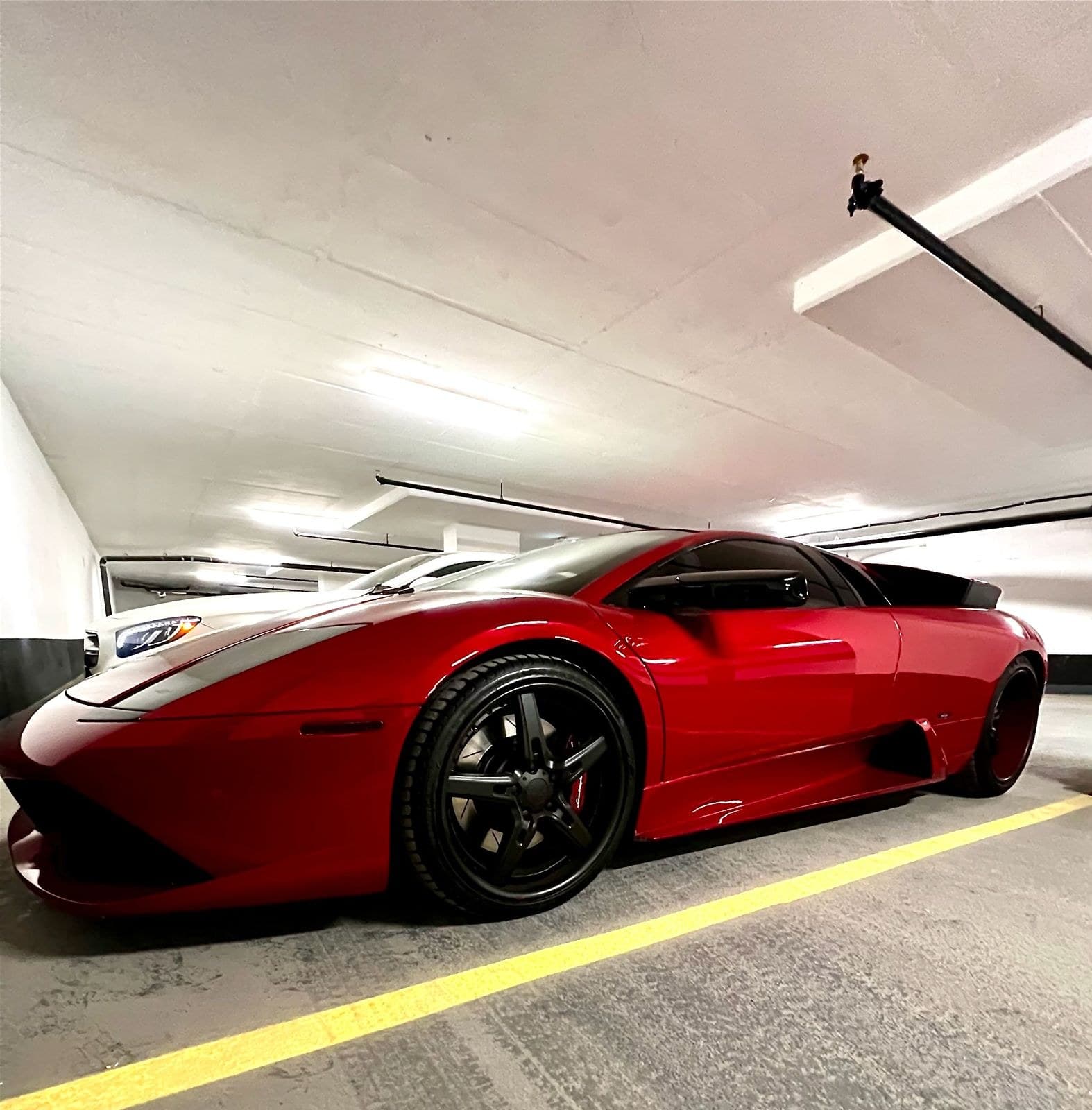 Front three-quarter view of the red Murciélago on black five-spoke wheels