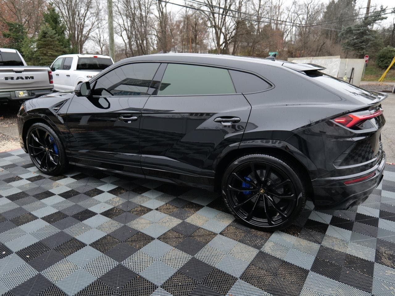 Rear three-quarter view of the 2021 Lamborghini Urus showing the sloping roofline and roof spoiler