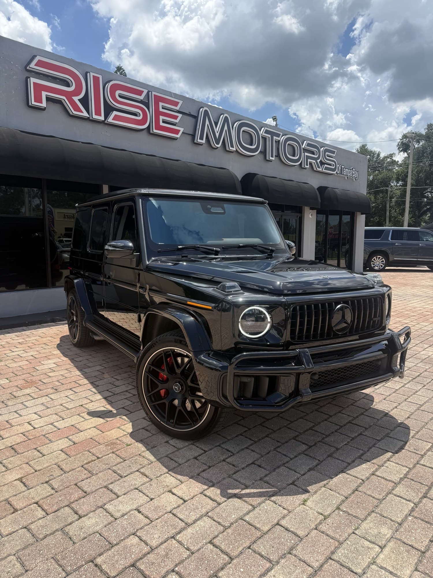 2025 Mercedes-AMG G 63 in black with blacked-out trim and brush guard — front three-quarter view, for sale from DDE Rentals