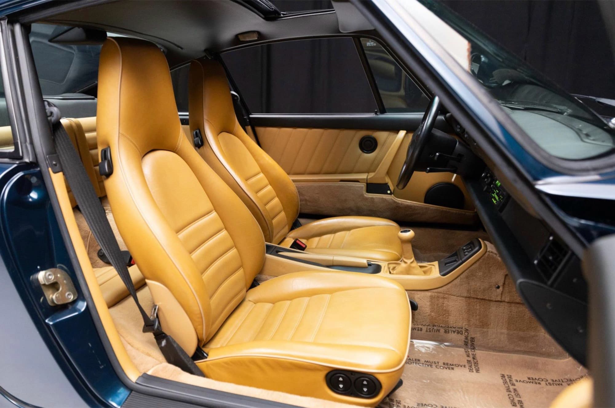 Tan leather sport seats and door cards inside the 1993 Porsche 911 Carrera 2 (964)