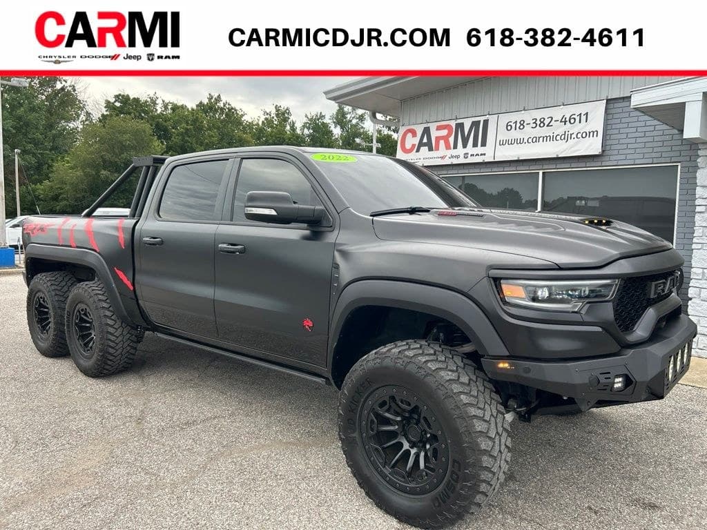 2022 Ram 1500 TRX 6x6 in matte black with red TRX graphics — front three-quarter view showing the tandem rear axles, for sale from DDE Rentals